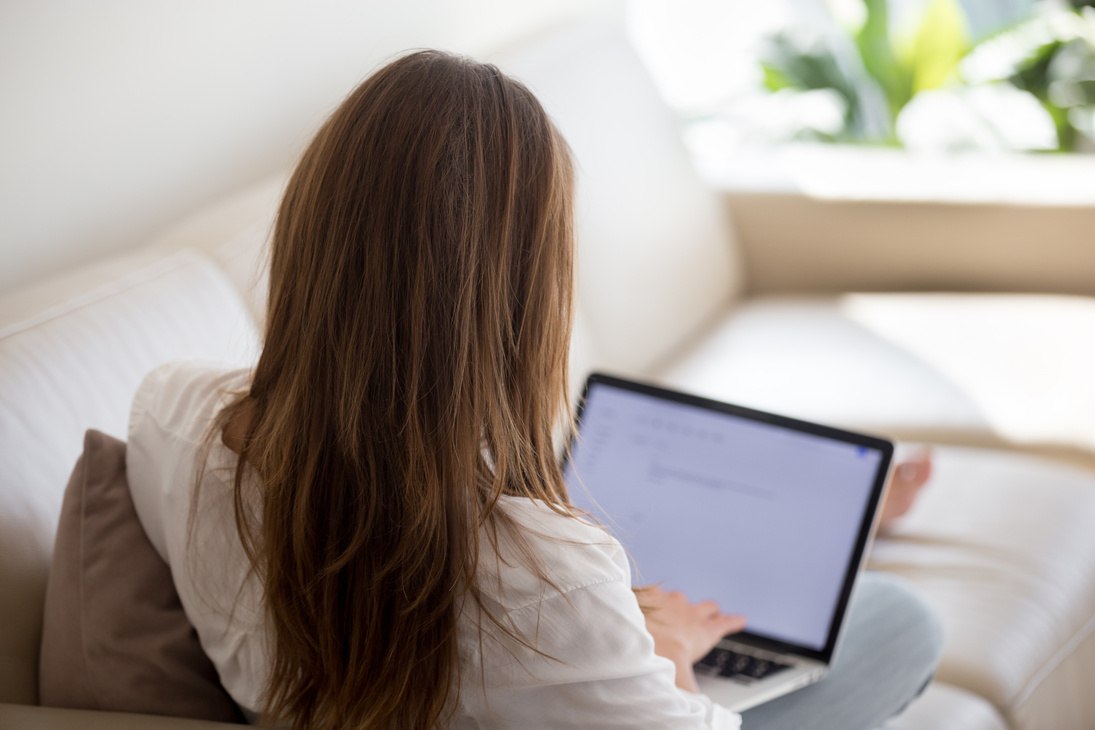 Woman using laptop for typing email letter or writing blog